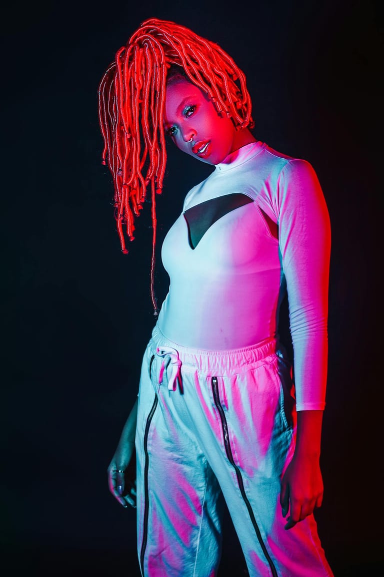 Studio portrait — vibrant locs, streetwear